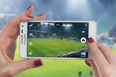 A woman testing the 5 best apps to watch football in Spanish from an android